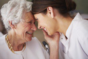 elderly woman thanking her home caregiver