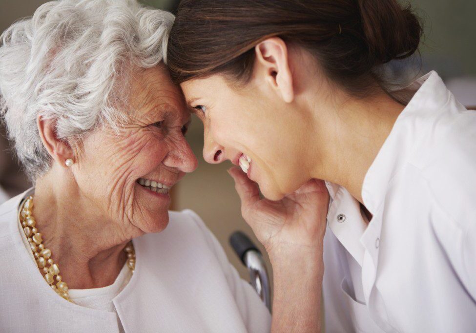 elderly woman thanking her home caregiver